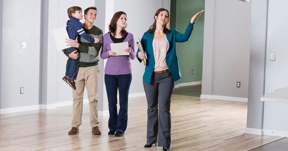realtor-showing-young-family-empty-house_573x300.jpg