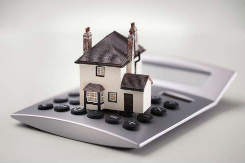 bigstock-House-resting-on-calculator-co-82188245.jpg